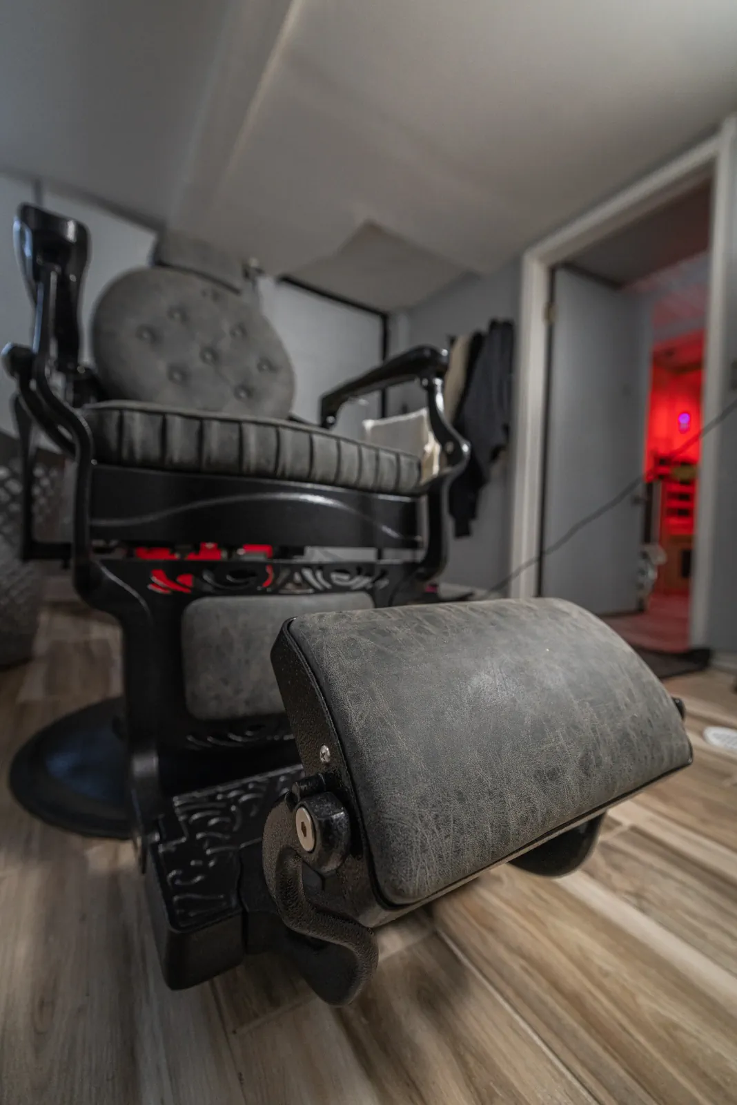 Barber chair footrest leading into The Chop Shop private grooming suite