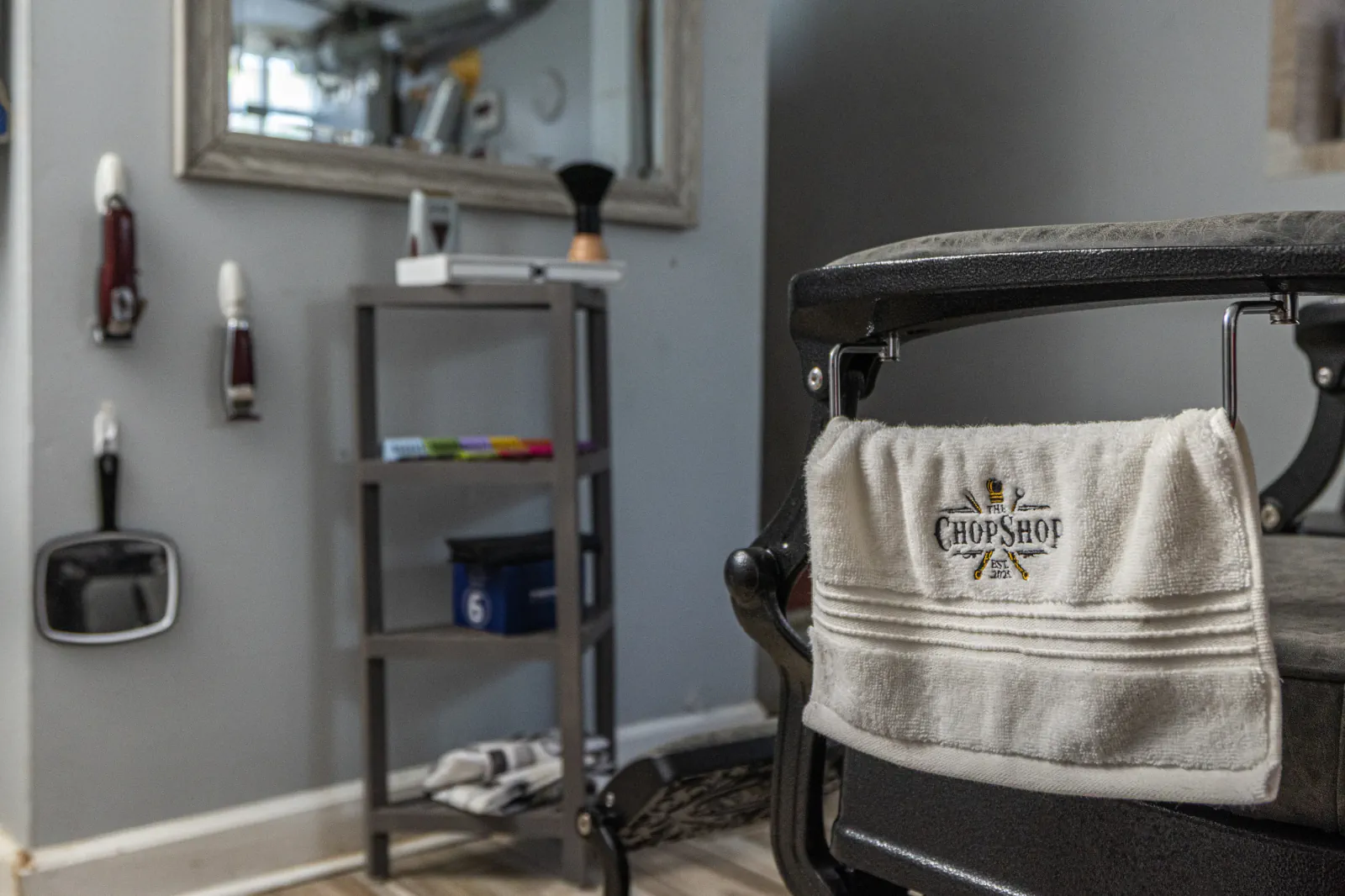 The Chop Shop barber chair with branded towel and grooming tools