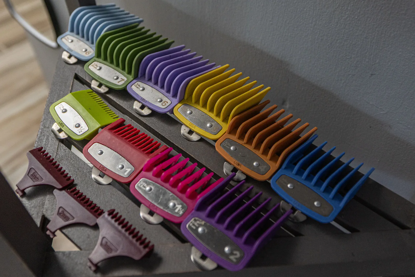 Color-coded hair clipper guards organized at The Chop Shop