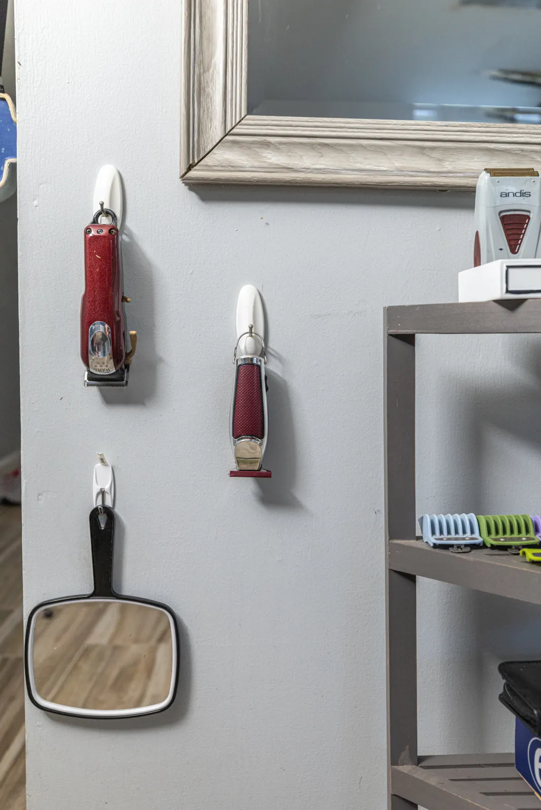Wall-mounted clippers, mirror and workstation in The Chop Shop
