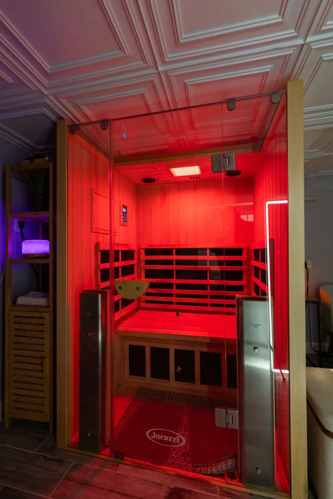 Open infrared sauna glowing red inside Heaven Beauty and Spa
