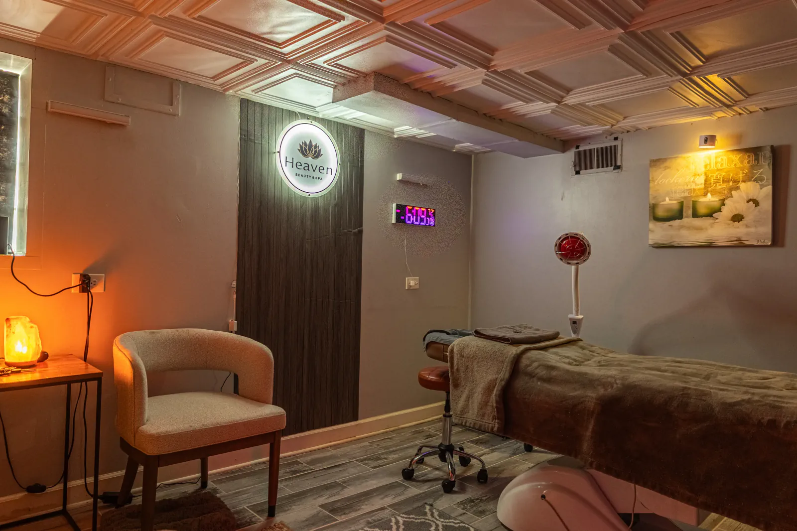 Wide view of the Heaven treatment room with chair, table and recovery equipment